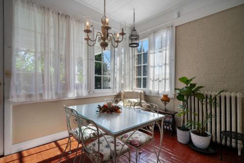 a dining room with a table and chairs and windows at The Inn on Front Street in Statesville