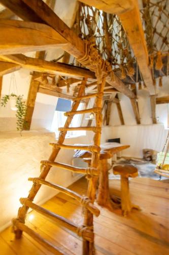 a wooden ladder in a room with wooden floors at Nid d amoureux in La Roque-Gageac