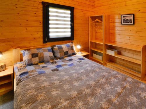 a bedroom with a bed in a log cabin at Holiday homes, Ustronie Morskie in Ustronie Morskie