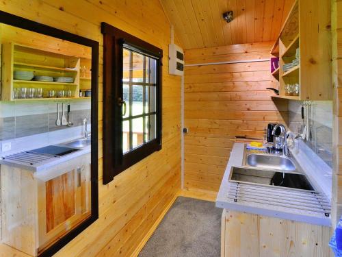 a kitchen with wooden walls and a sink at Holiday homes, Ustronie Morskie in Ustronie Morskie