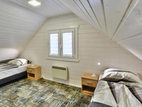 a small room with two beds and a window at Holiday resort, Grzybowo in Grzybowo