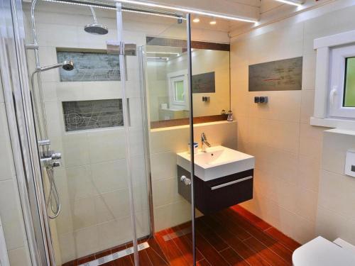 a bathroom with a shower and a sink at Chalet in Grzybowo near the Beach in Grzybowo