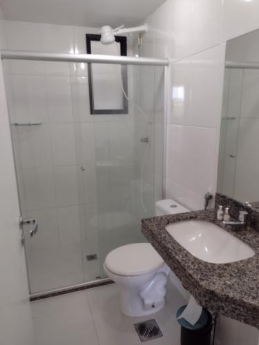 a bathroom with a shower and a toilet and a sink at Apt Estrada do coco- Lauro de Freitas in Lauro de Freitas