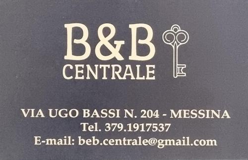 a sign for a car dealership with a key on it at B&B CENTRALE in Messina