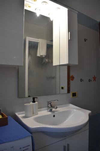 a bathroom with a white sink and a mirror at La casa di Mimmo in Rome
