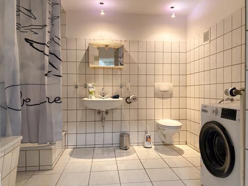 a bathroom with a washing machine and a sink at Accomodation in wuppertal in Wuppertal