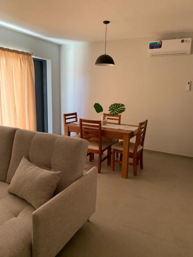 a living room with a couch and a table at Bosques de mayo Departamento 2 in Maipú