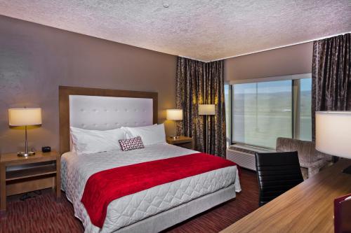 a hotel room with a bed and a large window at Shoshone Rose Casino & Hotel in Lander