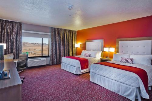 a hotel room with two beds and a large window at Shoshone Rose Casino & Hotel in Lander