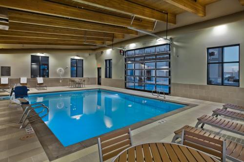 a large swimming pool with chairs around it at Shoshone Rose Casino & Hotel in Lander