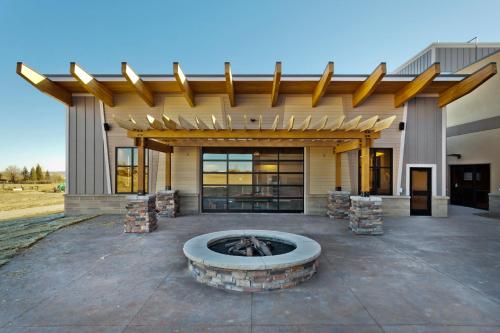 a building with a fire pit in front of it at Shoshone Rose Casino & Hotel in Lander