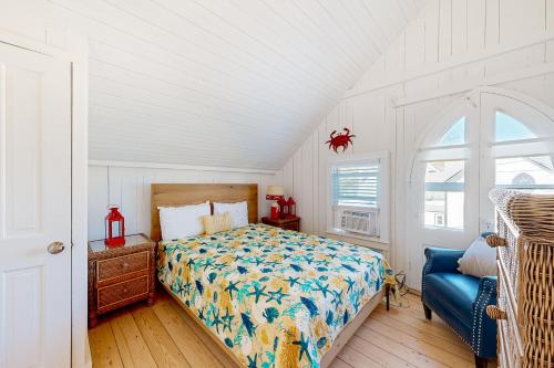 a bedroom with a bed and a blue chair at Victorian by the Sea in Oak Bluffs