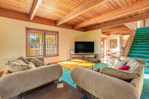 a living room with two couches and a television at Glacier-on-Ice in Kalispell