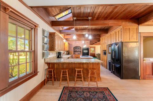 a kitchen with a large island with bar stools at Glacier-on-Ice in Kalispell