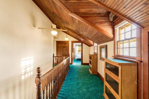 a hallway with a wooden ceiling and green carpet at Glacier-on-Ice in Kalispell