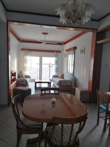 a living room with a table and a couch at Villa Evmenia Panoramic sea view & Sea front apartments in Skopelos Town