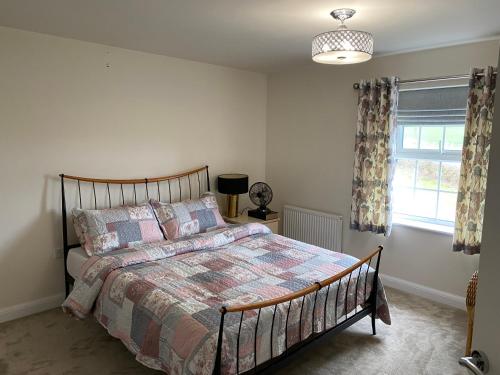 a bedroom with a bed and a window at Cosy Home in Quiet Village in Lincolnshire