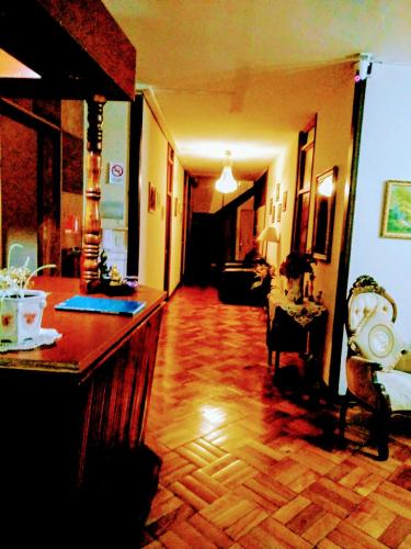 a living room with a hard wood floor and a hallway at the scandinavian in Valparaíso