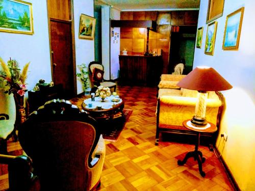 un salon avec une chaise et une table avec une lampe dans l'établissement the scandinavian, à Valparaíso