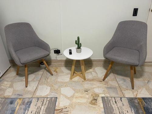 two chairs and a table with a cactus on it at Habitación Privada Laureles, Suit Medellin Jacuzzi in Medellín