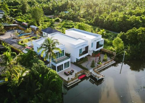 an aerial view of a house on the water at Yunoya Riverside Villa in Samut Songkhram