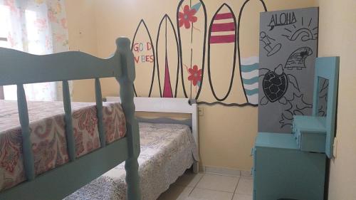 a bedroom with a bunk bed with surfboards on the wall at Casa /praia canto grande in Bombinhas