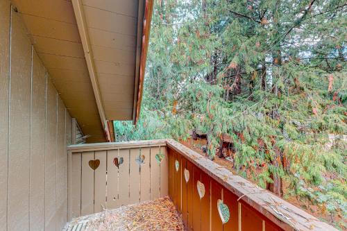 a porch of a house with a fence and trees at Little Sand Creek Chalet in Sandpoint