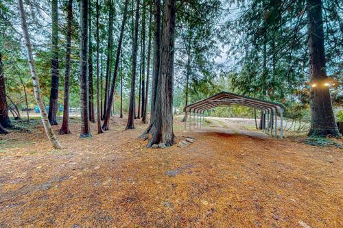 a canopy in the middle of a forest with trees at Little Sand Creek Chalet in Sandpoint
