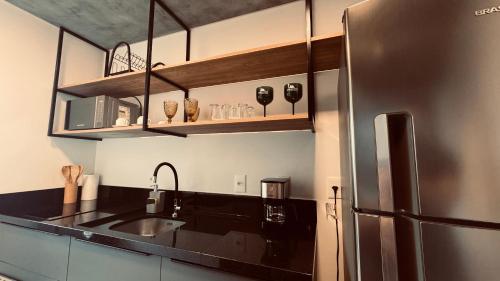 uma cozinha com um lavatório e um frigorífico em Loft de Luxo na Vila Germânica em Blumenau