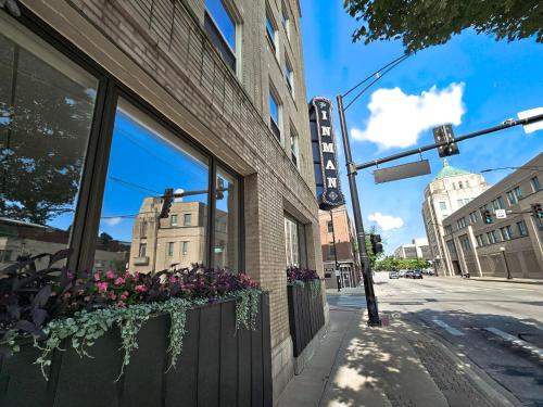 a building with a window with flowers on a street at Cute + Cozy Studio at The Inman - 207 in Champaign