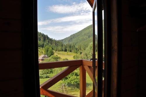 a view of a valley from a window at Kozichky Guest House in Tatariv
