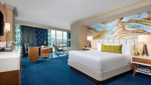 a hotel room with a bed and a dining area at Mandalay Bay in Las Vegas