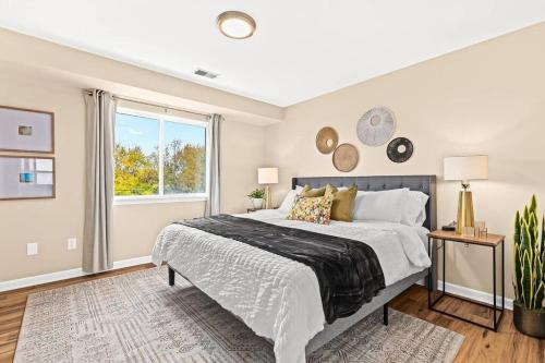 a bedroom with a large bed and a window at New! Modern Upper Flat near Downtown Roseville in Roseville