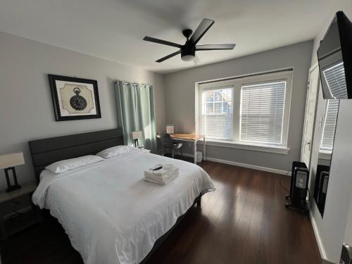 a bedroom with a bed and a ceiling fan at Stay with Jay in Cleveland 3 in Cleveland