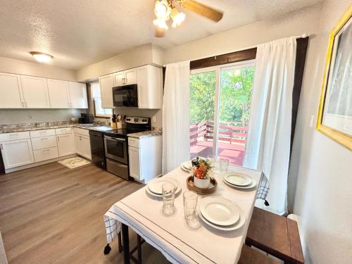 cocina con mesa blanca y cocina con ventana en Beautiful and Spacious Marion IA Apartment., en Marion