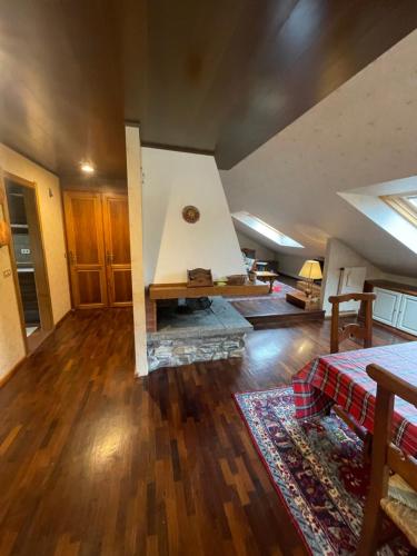 a large living room with a fireplace in a house at la mansarda di Fabio in Bormio