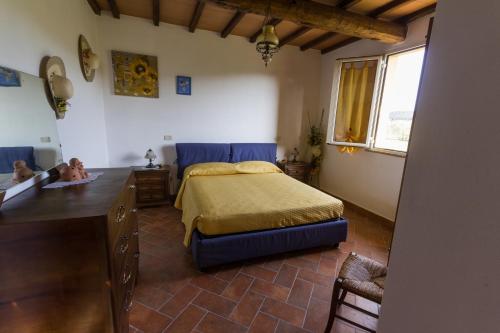 a bedroom with a bed and a dresser in it at Agriturismo Cupido in Montiano