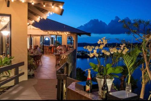 a restaurant with a view of the water at night at Island Daze - Amazing Views in East End