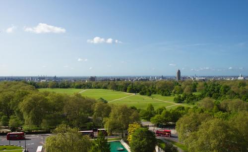 a view of a park with buses in a city at Lux Mews House Portobello 4 bed in London