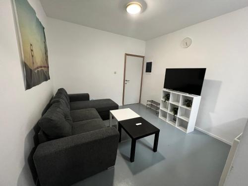 a living room with a couch and a table at Chez nous in Liège