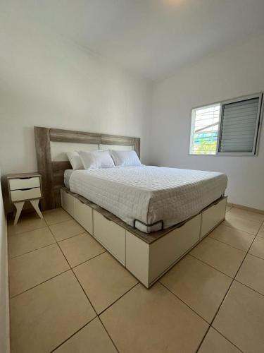 a bedroom with a large bed in a white room at Departamento para 4 Resistencia- Chaco in Resistencia
