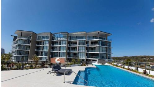 a large apartment building with a swimming pool at Solaris 310 in Forster