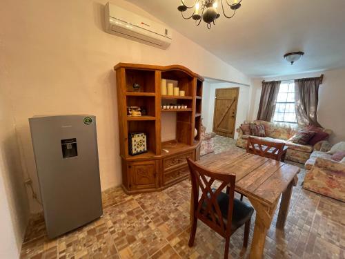 a living room with a table and a refrigerator at Bonito departamento con dos habitaciones. in Piedras Negras
