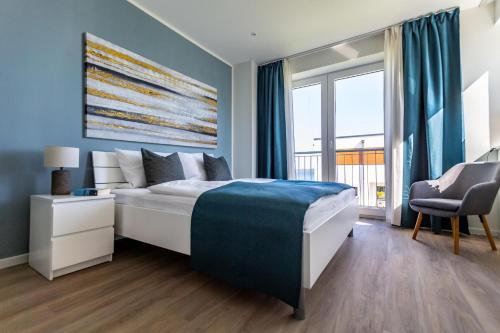 a bedroom with a bed and a large window at Hangar 19 Luxusapartment mit Sauna, Kamin, Dachterrasse und Seeblick H5W3 in Schwerin