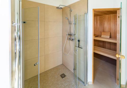 a shower with a glass door in a bathroom at Hangar19 in Schwerin