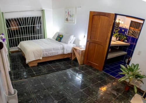 a small bedroom with a bed and a desk at Carbell House in La Cruz