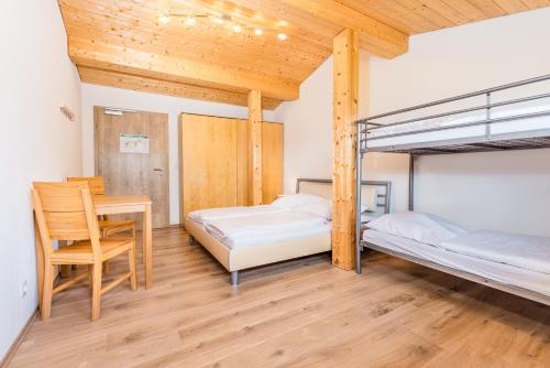 a bedroom with two bunk beds and a desk at Der Bradler in Ebhausen