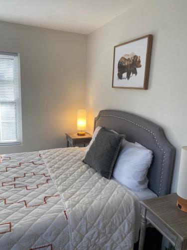 a bedroom with a bed and a table with a lamp at Cute private Wooded Cabin near the big lake in Tafton