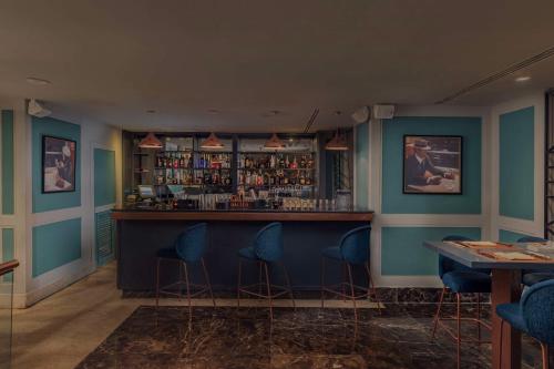 a bar with blue walls and blue stools at Radisson Blu Hotel, Cairo Heliopolis in Cairo