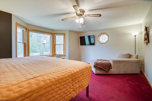 a bedroom with a bed and a couch and a ceiling fan at Family-Friendly Home in Pepin Walk to Main St! in Pepin